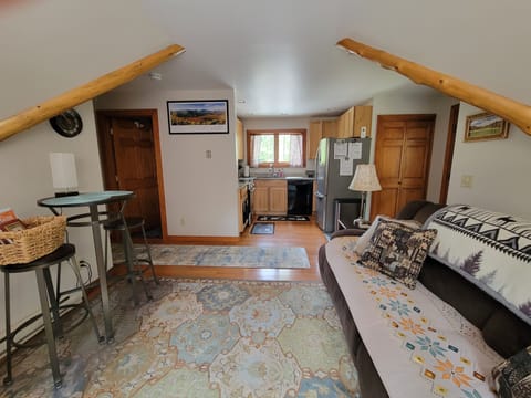 Deceptively spacious living room looking into the kitchen.