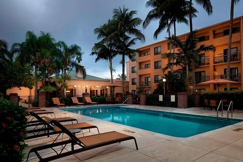Unwind poolside under swaying palms after a sunny day.