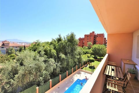 Private terrace with outdoor dining area for six guests and views to the pool and gardens