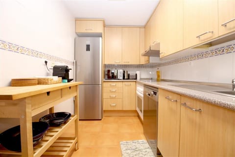 Modern kitchen in this appartment is fully equipped with quality appliances