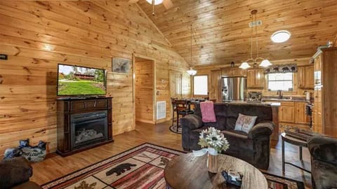 Enjoy wood-paneled charm, a warming fireplace, and movie nights on the big screen!