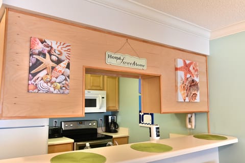 Open kitchen and dining space with breakfast counter and stools