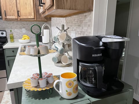 Single cup or drip coffee pot with grounds, sugar, and powdered creamer provided