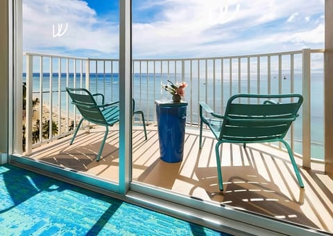 Sip morning coffee on the balcony overlooking shimmering blue water.