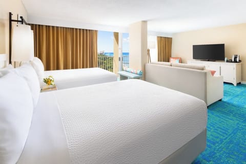 Stretch out in crisp linens with a breezy ocean peek.