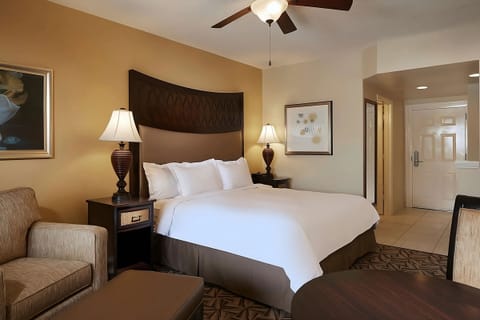 Unwind in crisp linens with warm lamplight and quiet comfort.