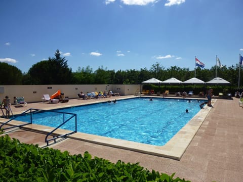 swimming pool with toddler pool and sunbathing chairs
