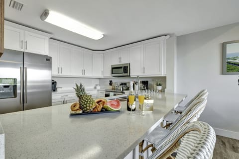 A pristine canvas of white cupboards elegantly lines the walls, creating a sense of purity and sophistication.