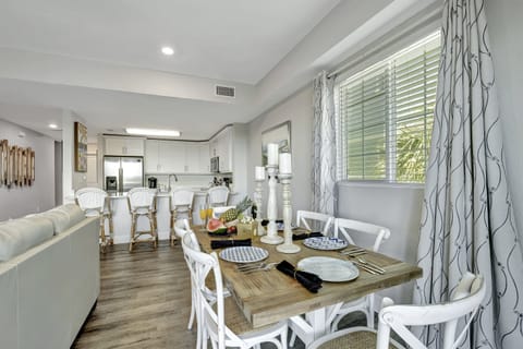 A grand six-seater dining table stands at the heart of this enchanting scene, a testament to both functionality and design.