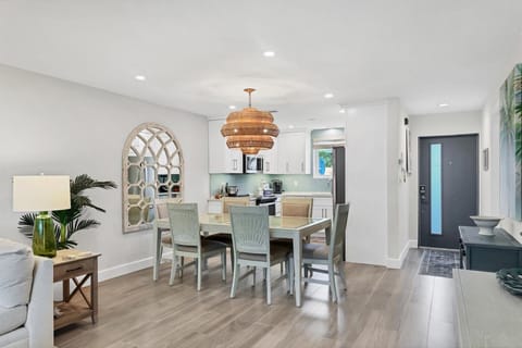 Gather around your elegant dining table in this beautifully appointed open-concept space featuring coastal-inspired decor and modern kitchen.