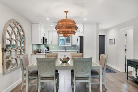 You'll love gathering around this elegant dining table under the stunning woven chandelier, with the fully equipped kitchen just steps away for easy meal prep.