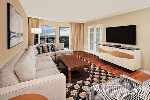Unwind on the sectional with sunshine and balcony views.