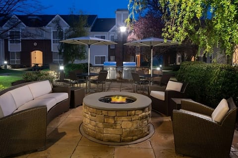 Unwind by the fire pit under twinkling evening lights.