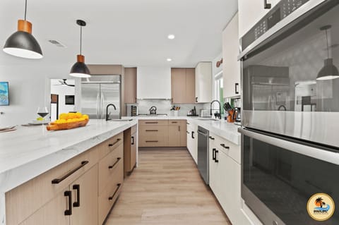 Kitchen with double ovens, two sinks, gas range & wine fridge—chef-ready!