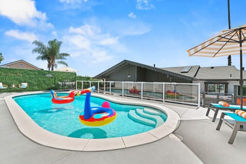 Spacious veranda with a pool, spa, loungers, dining area, BBQ where fun happens