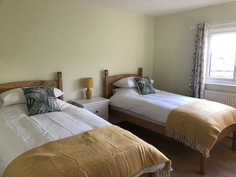 Twin bedroom with wardrobe and chest of drawers.