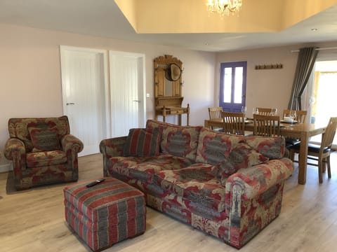 Comfy couch and 2 chairs, and large dining table comfortably seating 4 people.