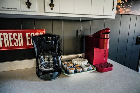 Coffee station with a coffee maker, Keurig machine, and pods in the kitchen.