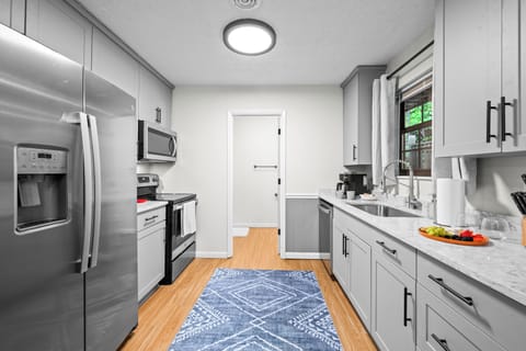 Fully stocked kitchen includes full size electric stovetop, oven, & microwave  