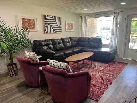 Living room with large picture window and natural light. 65" Smart TV on opposite wall. High speed wireless internet.