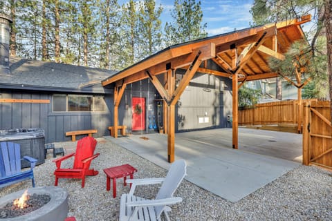 Spacious covered patio with exposed wood beams, outdoor seating, and private setting. Perfect for relaxing year-round, enjoying morning coffee, or gathering with friends in a peaceful mountain retreat.