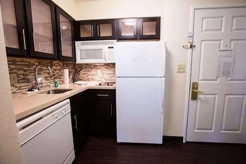 Prepare simple meals with full-size fridge, microwave, and cooktop.