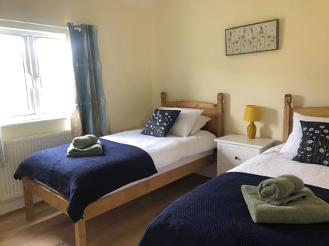 Twin Bedroom with hanging space and chest of drawers. 
