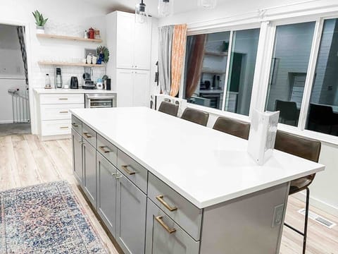 Newly remodeled kitchen with large island and beverage area.