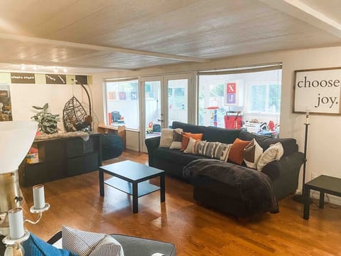 large downstairs living and play room with sofa bed.