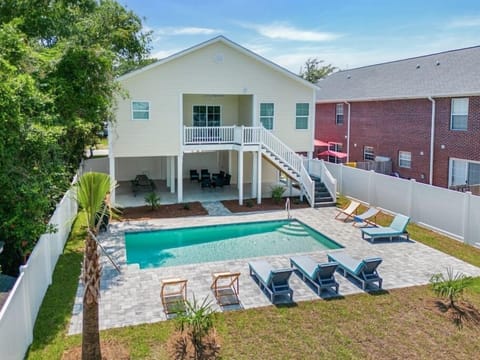 Spacious backyard with private pool, grill, firepit, and lounge and dining areas