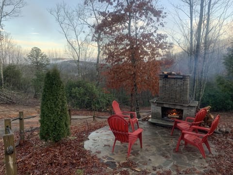 Outdoor fireplace with mountain views just steps from the front door of cabin