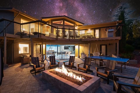 Jumbo firepit and gameroom in the background. Huge deck top and bottom.