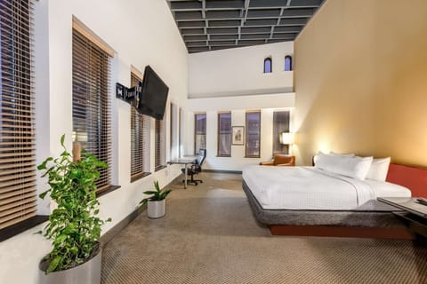 Stretch out in a loft-style bedroom with warm evening light.