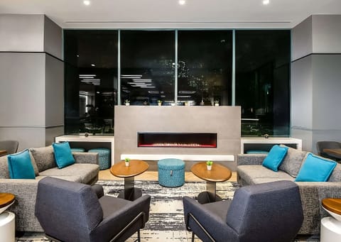Unwind by the glowing fireplace in a stylish lounge setting.