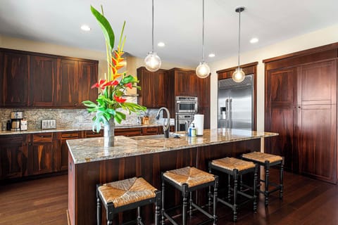 Granite kitchen island with breakfast bar seating for four.