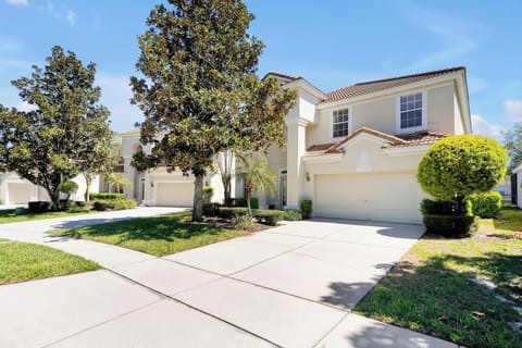 Spacious suburban home with a two-car garage and lush landscaping.