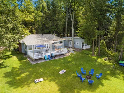 Lakeside yard, showing deck and fire pit with seating.