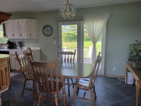 Dining area leading out to back deck and parking