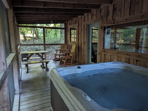 Hot Tub, rocking chairs and a picnic area on a covered screen porch,