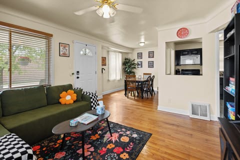 Living room with games, popcorn machine, extra blankets and Detroit artwork.