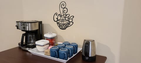 Coffee/tea station; coffee grounds, sweeteners, and coffee grinder provided.