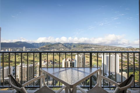 Sweeping mountain and cityscape views frame this private balcony, where you can enjoy morning coffee or evening relaxation with Hawaii's dramatic landscape stretching before you.