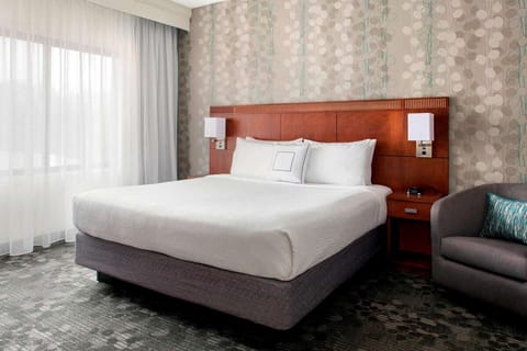 Sink into plush comfort beside soft daylight and quiet calm.