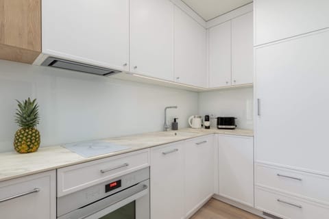 Close-up of a kitchen corner showing modern appliances, including a kettle and a toaster, for added convenience.