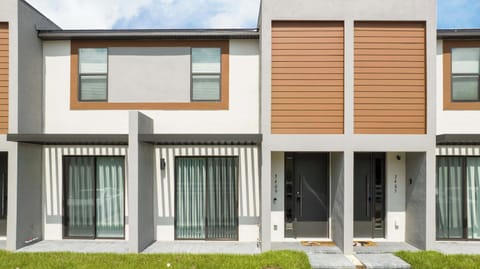 Welcome to 3409 at The Hub Westside-sleek, modern townhouse with clean lines, warm wood accents, and bright sliding doors.