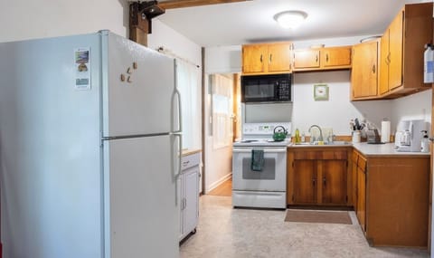 A cozy, fully stocked kitchen is at your disposal for cooking.