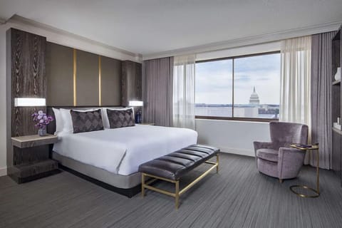 Sink into a king bed with a skyline backdrop.