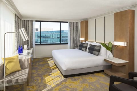 Unwind in a bright corner room with plush bedding.