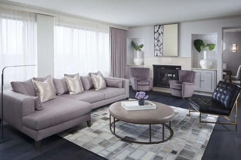 Lounge by the fireplace in a bright, stylish seating area.