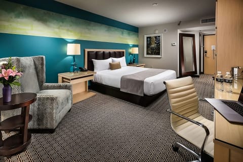 Settle into a cozy room with workspace and plush seating.